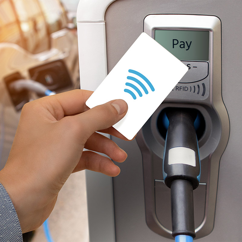 Person using RFID card to pay at a charging station